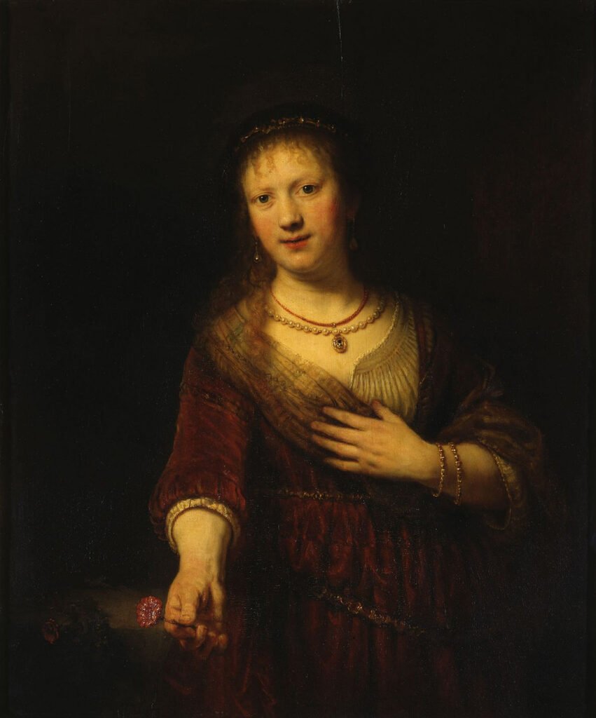An oil painting of a woman holding a red flower in her right hand. her left hand is held at her chest and she looks towards the viewer. The background is very dark and the woman painted in yellow tones as if emerging from darkness.