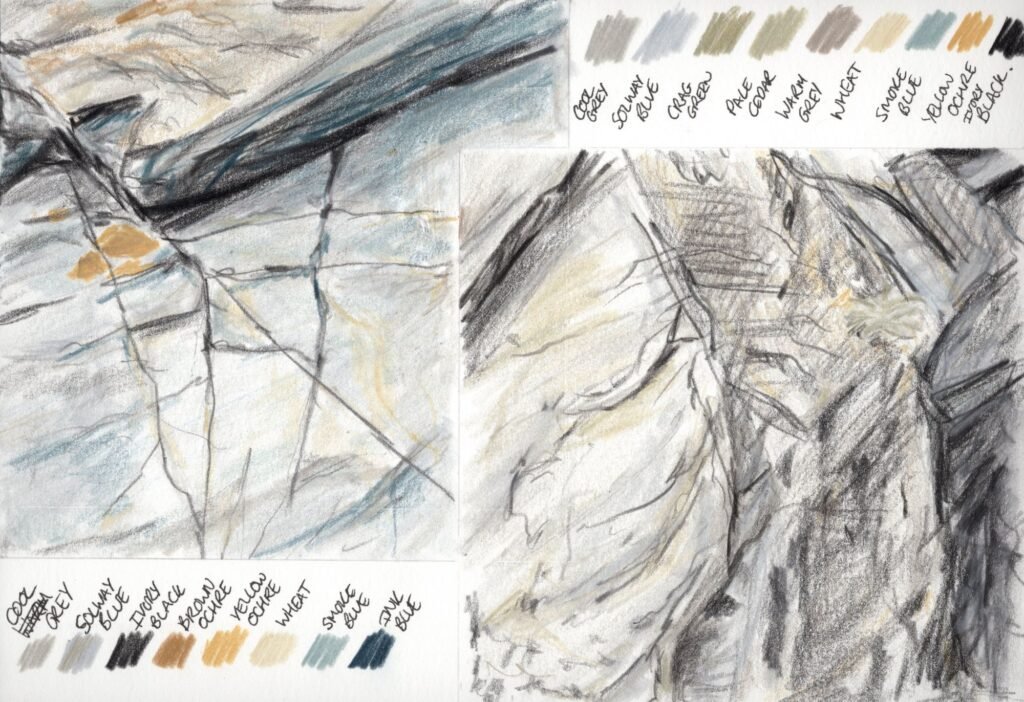Two sketches of rocks on a beach with lichen, completed in coloured pencil.