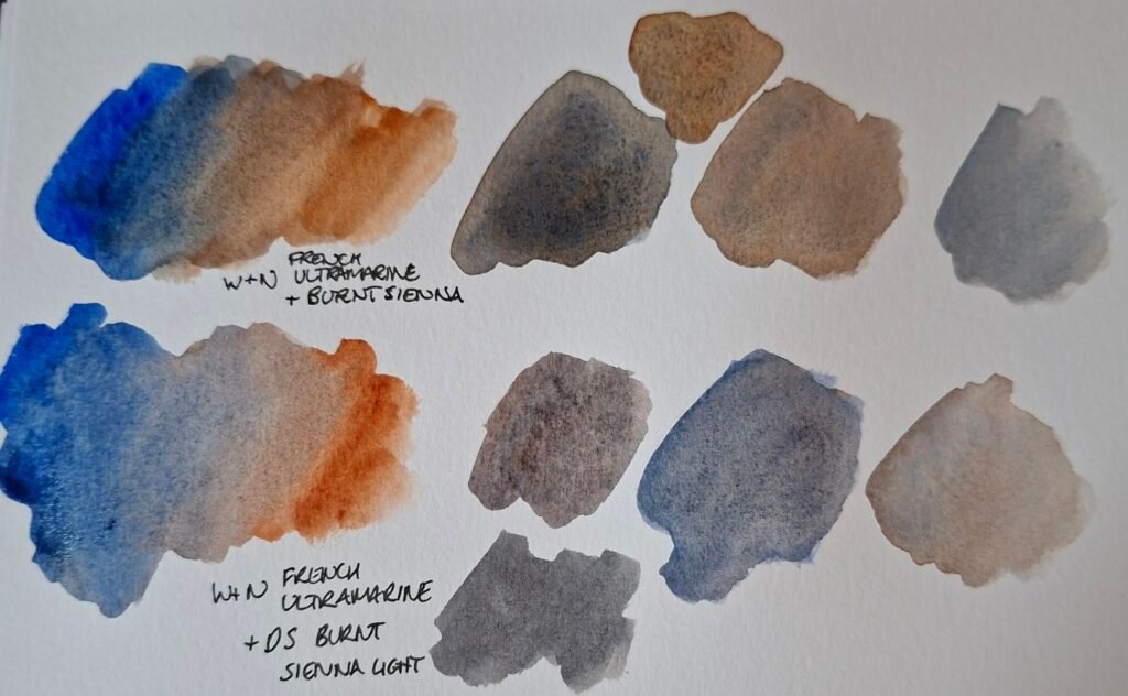 A series of mixes of blue and brown-orange watercolours. Many of the mixes are grey with a hint of blue or orange.