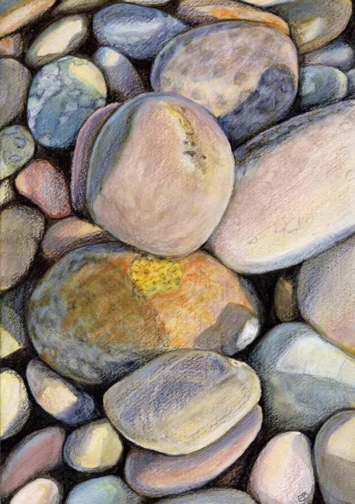Watercolour and coloured pencil drawing of pebbles on a beach in close up.