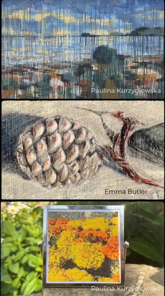 A photo-montage of three artworks that have recently been added to the IOMNJ map. The top and bottom images are by Paulina Kurzydlowska - the top one being an acrylic painting of a view from a rocky beach painted in a style that involves dripping the paint from each area of colour. The lower artwork is a cross stitch of yellow flowers. The middle image is an artwork by Emma Butler showing a pinecone and pebbles on a beach, drawn in coloured pencil on an acrylic paint base.