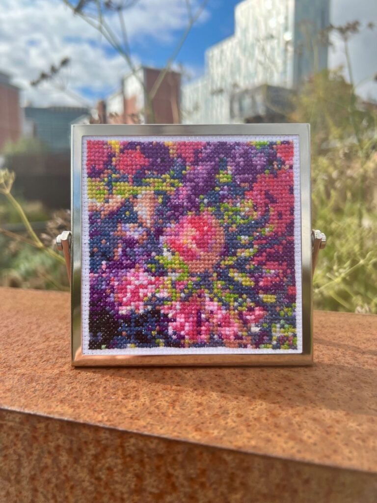 'Floral Abstraction' by Paulina Kurzydlowska - a cross stitch of pink and purple flowers.