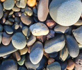 Point of Ayre Close-up of pebbles in many colours on a beach.